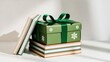 © mila103 - Green gift box with snowflakes and books in bright sunlight.