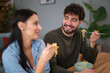 © Dexon Dee - Happy young couple enjoying a casual noodle meal