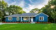 © good - Blue suburban ranch house with manicured lawn, landscaping, and bright sunny sky