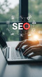 © Pixample - SEO specialist typing on laptop with digital marketing hologram icons and analytics