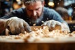 © zhuan - gloved hands planing a wooden board with flying shavings in a busy workshop, focused gritty craftsmanship
