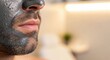 © Nataly - Close up of mens facial mask applied to man's face with stubble, detailing purifying skin care treatment. Mens facial mask helps deep cleanse pores, remove impurities, and rejuvenate skin,