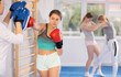 © JackF - Teen girl in punch mitts boxing and practicing in gym
