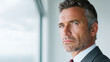 © Watercolor_Kawaii - Confident man mature man serious expression business attire close up blue eyes gray hair facial hair indoor natural light professional thoughtful focused middle aged caucasian formal wear suit tie