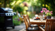 © Kateryna - Summer time in backyard garden with BBQ grill and wooden table blurred background outdoor entertaining setup patio lifestyle cooking area warm season heavily defocused