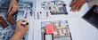© InfiniteFlow - A group of individuals collaborates on an interior design project, showcasing colorful notes, detailed sketches, and tools spread across a table, emphasizing teamwork and creativity. SACTR