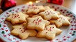 © Faizer - Festive Christmas Star Cookies Adorned with Red Sprinkles on a Decorated Plate, Softly Lit in a Cozy Kitchen Setting