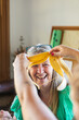 © Shava Cueva/Stocksy - A daughter has fun with a banana peel in front of her mother's face.