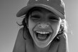 © Stephanie Tamir/Stocksy - A boy smiling on a close up photo in black and white