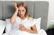 © brizmaker - Woman suffering headache in bed at home
