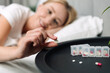 © brizmaker - Young woman takes medication in bed for daily health routine at home
