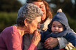 © Raul Navarro/Stocksy - Grandmother kissing hand of her grandson