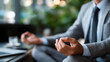 © Laura - Faceless person meditating at office wearing suit in meditation, relaxation at work concept, workplace mindfulness, professional stress relief, with copy space