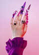 © Lilit Lysa/Stocksy - Woman's hand with very long colourful art nails manicure