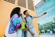 © Lightsy/Stocksy - College students taking a selfie on campus