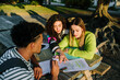 © Lightsy/Stocksy - College students studying at a park