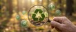 © Prime path 515 - Environmental sustainability concept with recycling symbol under magnifying glass in forest background for eco research and green technology development