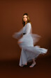 © Tania Cervian/Stocksy - Young woman dancing wearing elegant dress with motion blur effect