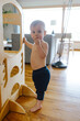 © Katy Weaver/Stocksy - Toddler Standing and Snacking at Home