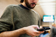 © Rachel Schmidt/Stocksy - Young man using cell phone in Chicago subway station