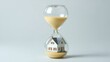 © Manutsanun - The urban real estate crisis ,Hourglass with sand flowing over a miniature house, symbolizing time and property.