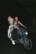 © Laura Herrera/Stocksy - Drag queen on motorcycle with smiling man