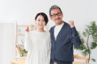 © polkadot - ガッツポーズするミドル世代の夫婦