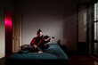 © Ibai Acevedo/Stocksy - Happy woman playing violin at cinematic bedroom