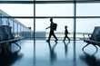 © Yic Ma/Stocksy - Silhouette of father and son walking at airport window