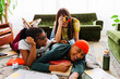 © BONNINSTUDIO/Stocksy - Students taking a break from studying, having fun with retro camera