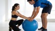 © Dorothy - Man assisting woman with exercise ball