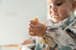 © Raul Navarro/Stocksy - Baby eating food with hands