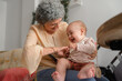 © Raul Navarro/Stocksy - Grandmother tickling her grandson