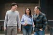 © Franci Leoncio - Happy diverse colleagues walking and discussing in office hallway