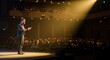 © Manzar - A confident speaker presents to a large audience in a brightly lit auditorium