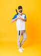 © luismolinero - Full-length shot of man over isolated yellow background playing baseball