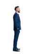 © Viorel Sima - Smiling businessman standing with hands in pockets looking side