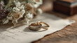 © Lumi Stock Studio - luxury wedding rings on vintage letter with dried flowers, elegant gold wedding bands resting on antique paper, rustic wedding rings aesthetic with floral bouquet on wooden table