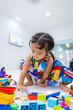 © themorningglory - Adorable kindergarten asian girl enjoy play colorful toy block building
