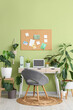 © Pixel-Shot - Interior of office with workplace, pin board and houseplants