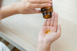 © Pormezz - person prepare fish oil pills to her hands taking daily supplement