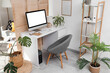 © Pixel-Shot - Interior of office with workplace, folding screen and plants