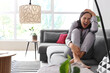 © Pixel-Shot - Beautiful young afraid woman sitting on sofa and screaming in living room