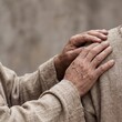 © JARVIS X - Elderly Person Comforting Another with Hand on Shoulder Showing Empathy and Support, Human Connection and Care Concept with Copy Space
