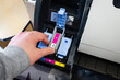 © hasbisahin - Man hand inserting a new magenta ink cartridge into the open bay of a large format office printer (plotter printer)