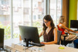 © Nuria Seguí/Stocksy - Woman at her desk, engrossed in computer work