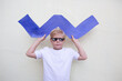© Iryna Auhustsinovich/Stocksy - Boy with cardboard blue zigzag