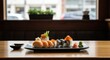 © DAVA - Sushi plate on a wooden table, near a window overlooking a city street