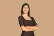 © Stock 4 You - Isolated corporate portrait of young business office female woman leader CEO boss manager looking at camera at beige wall. Successful latin hispanic or middle eastern businesswoman with crossed arms