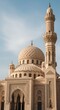 © Muhammad - Grand Mosque with Ornate Dome and Towering Minaret Against Blue Sky.